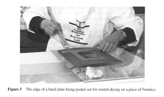 Edge of lined plate being pasted out for stretch drying on Formica